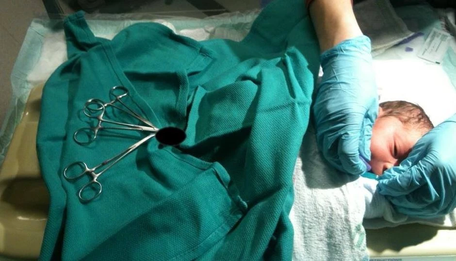 Censored context image showing an infant restrained on a circumstraint-style board; no explicit imagery.